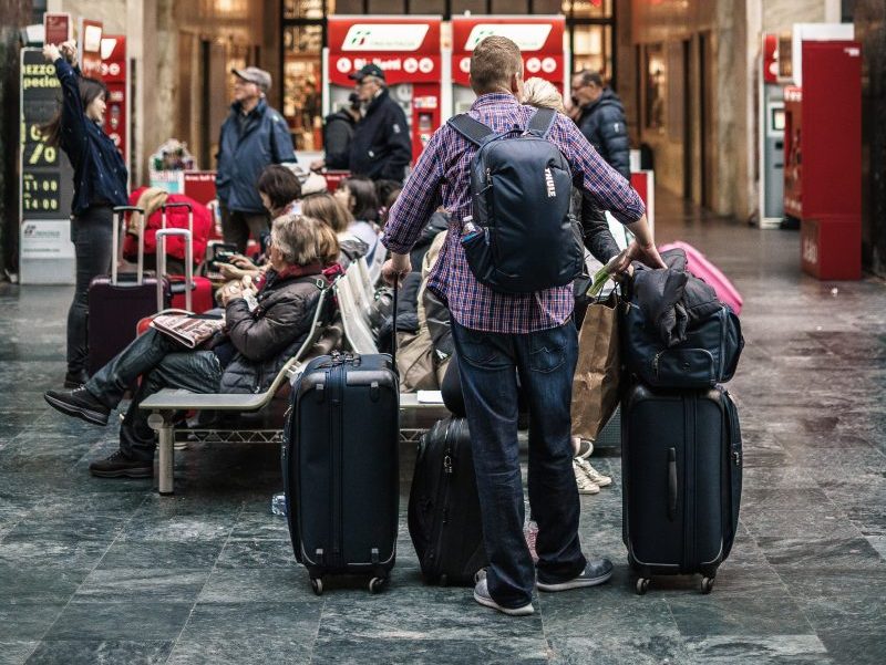 person standing beside the luggage bags